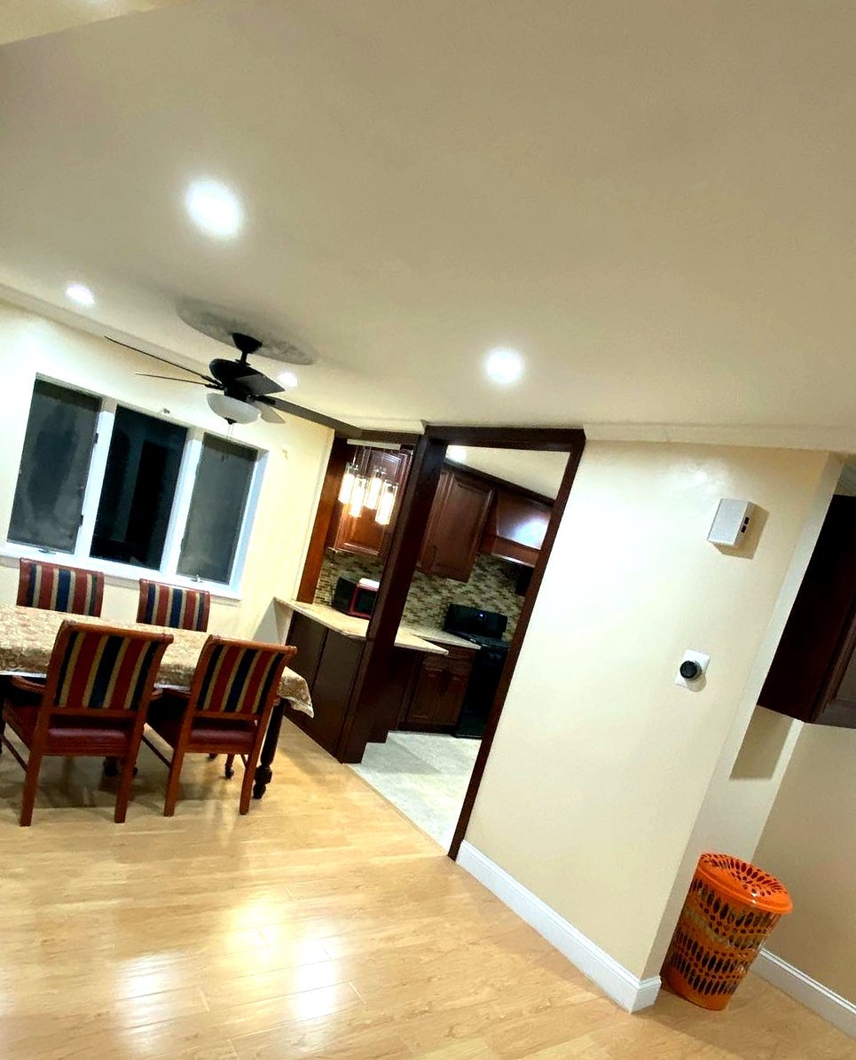 After: dining area with new wood flooring and mahogany trim