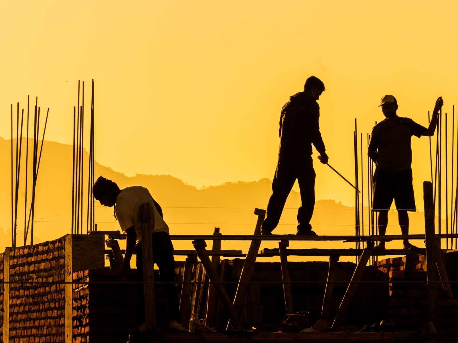 Structural framing under construction at sunset