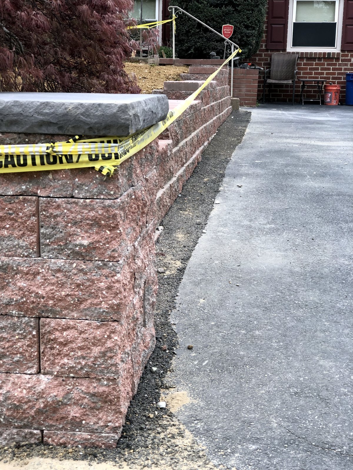 Close view of the capped block retaining wall beside the driveway