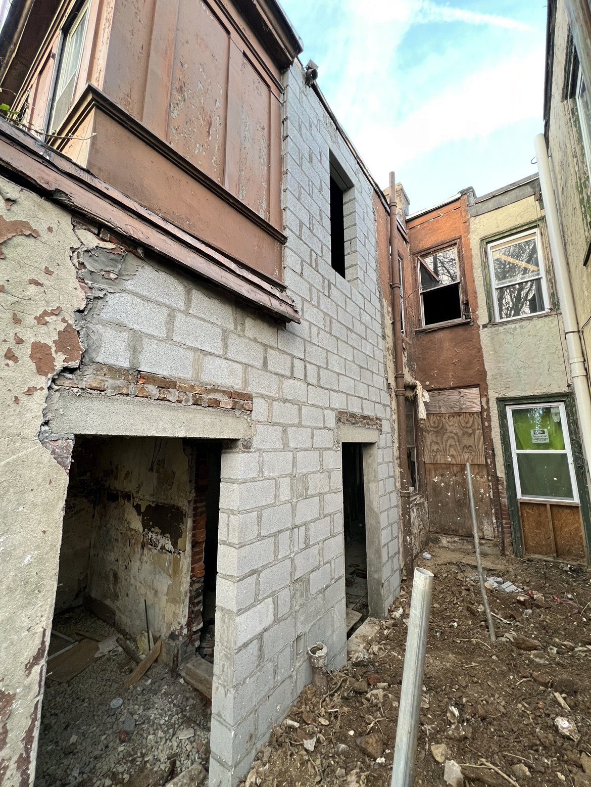 Concrete block (CMU) foundation wall at the rear of a row house