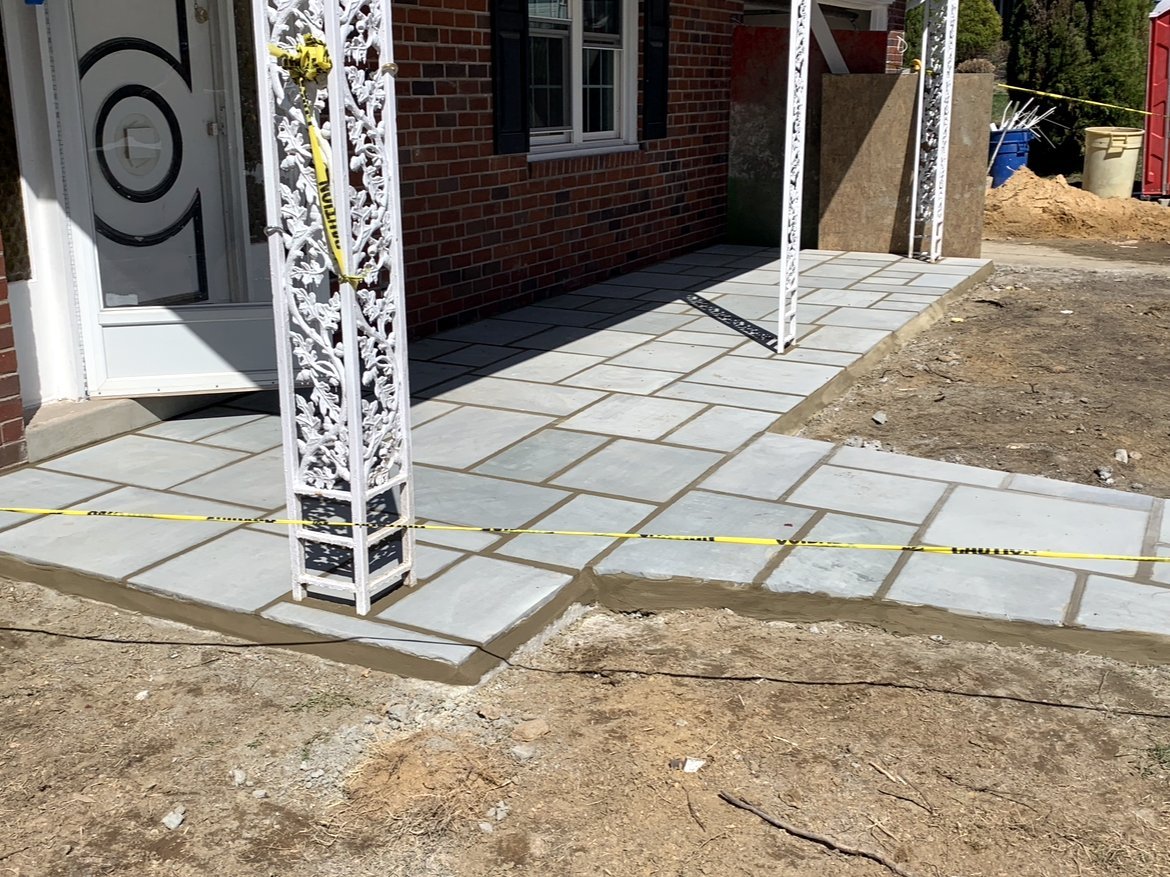 Flagstone walkway and landing at a front entry beside a column